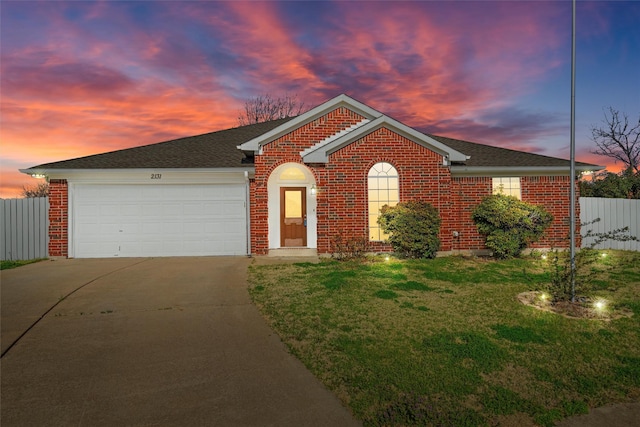 ranch-style house featuring a front lawn, fence, concrete driveway, an attached garage, and brick siding