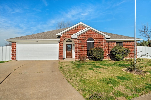 ranch-style home with a front lawn, fence, concrete driveway, an attached garage, and brick siding