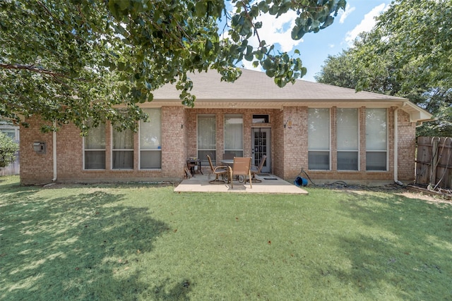 back of property featuring a patio, a yard, fence, and brick siding