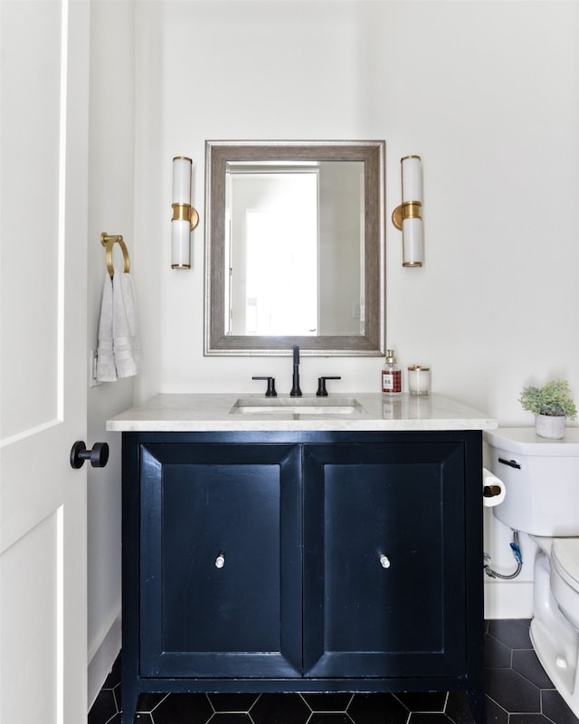 bathroom featuring vanity, tile patterned floors, and toilet