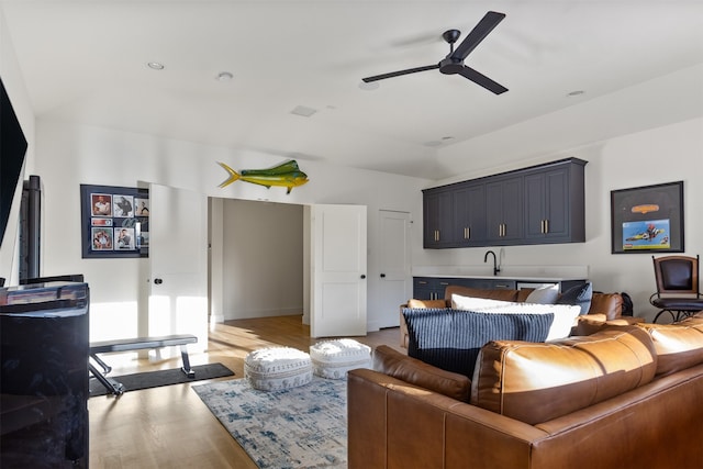 living room with wood finished floors and ceiling fan