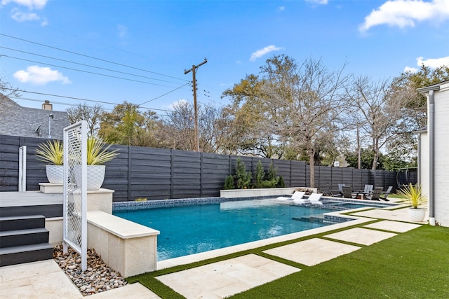 view of pool featuring a fenced in pool, a fenced backyard, and a patio area