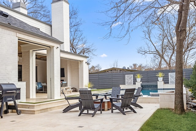 view of patio / terrace with a fenced in pool, a grill, and a fenced backyard