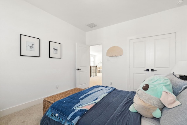 carpeted bedroom with baseboards, visible vents, and a closet