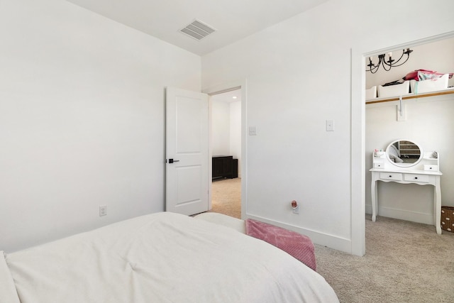 carpeted bedroom featuring visible vents and baseboards