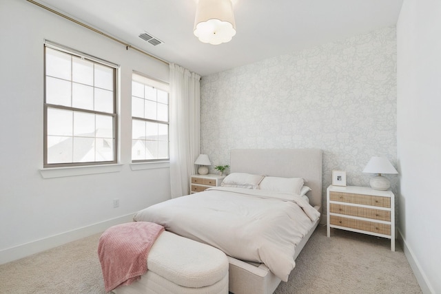 bedroom with visible vents, baseboards, carpet, and wallpapered walls