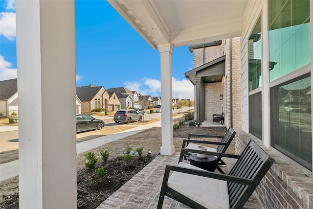 view of patio / terrace featuring a residential view and covered porch