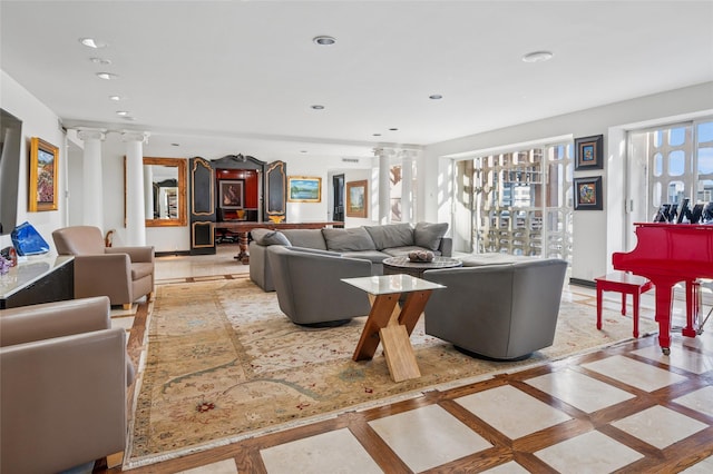 living room with recessed lighting and decorative columns