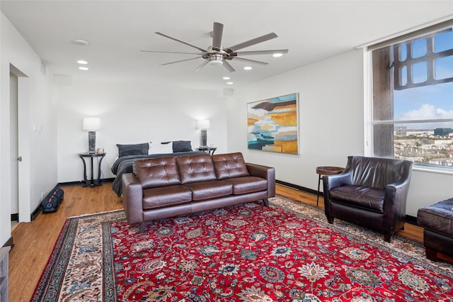 living area with recessed lighting, baseboards, ceiling fan, and wood finished floors