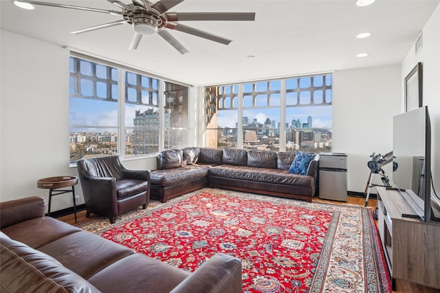 living room featuring wood finished floors, visible vents, recessed lighting, a ceiling fan, and baseboards