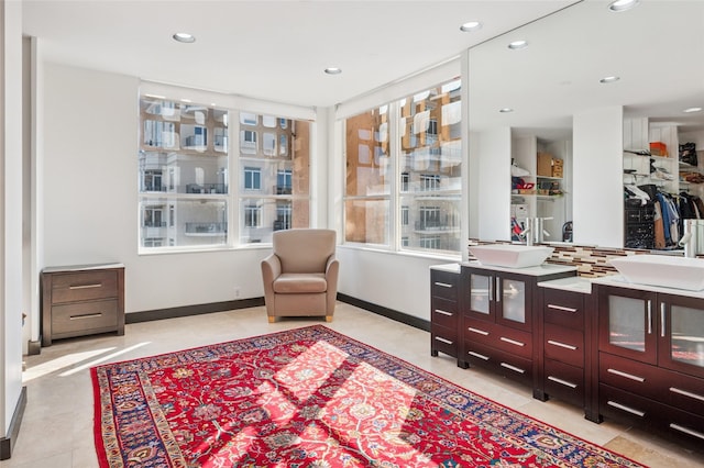 sitting room featuring recessed lighting, baseboards, and light tile patterned floors