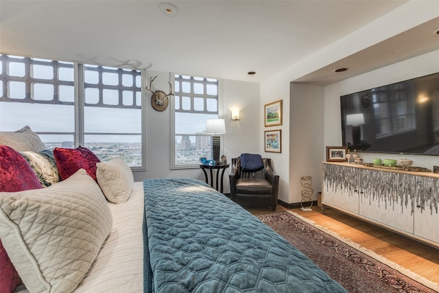 bedroom featuring wood finished floors and baseboards