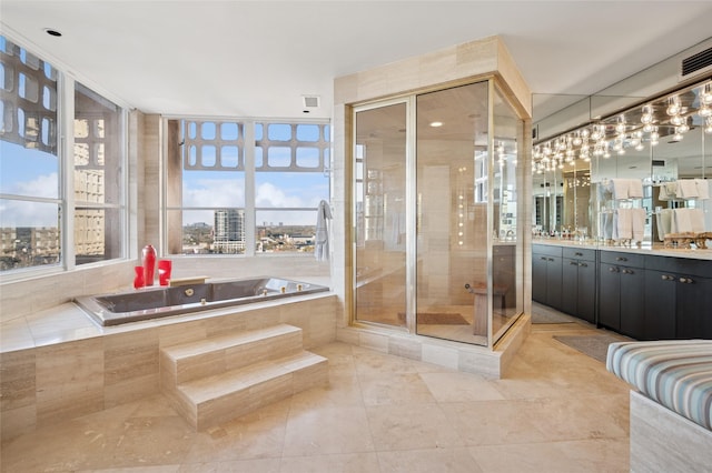 full bath with a stall shower, visible vents, tile patterned flooring, a garden tub, and vanity