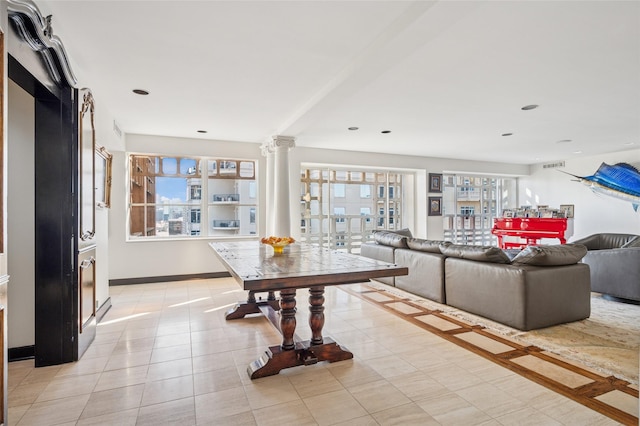 living room featuring baseboards, recessed lighting, visible vents, and ornate columns