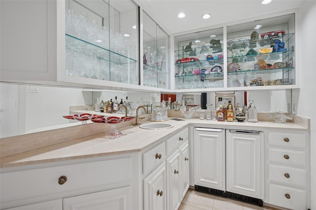 bar featuring a sink, indoor wet bar, and recessed lighting