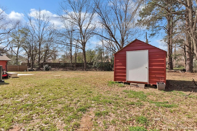 view of yard with an outbuilding, fence, and a shed