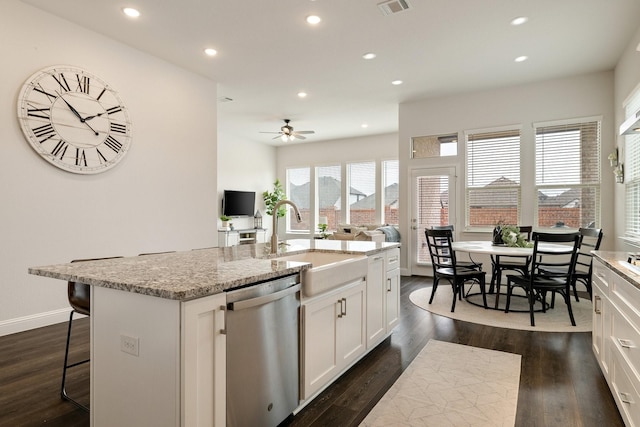 kitchen featuring a center island with sink, dark wood-style flooring, a sink, white cabinets, and stainless steel dishwasher