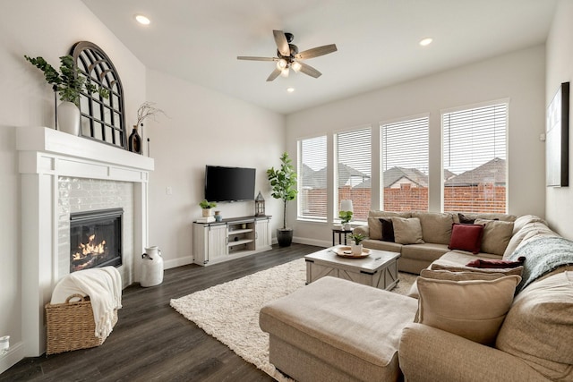 living area with recessed lighting, a fireplace, dark wood-type flooring, and ceiling fan