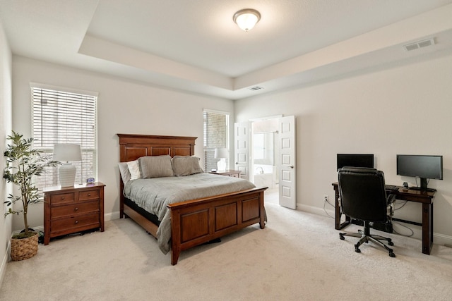 bedroom with light carpet, visible vents, a raised ceiling, and baseboards