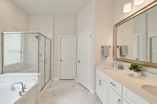 bathroom featuring a garden tub, marble finish floor, a marble finish shower, and a sink