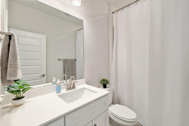 bathroom with visible vents, toilet, vanity, and a shower with curtain