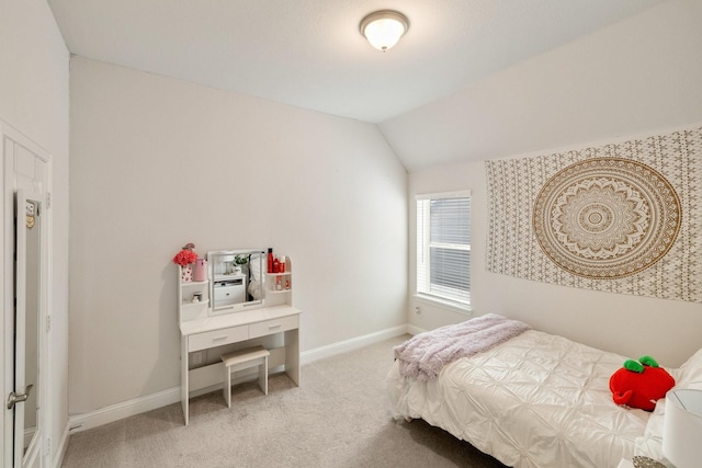 bedroom with baseboards, lofted ceiling, and light carpet