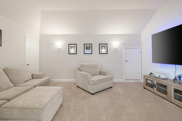 living room with vaulted ceiling, baseboards, and light carpet