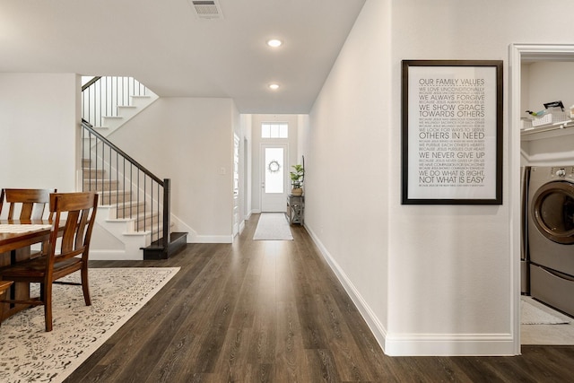 foyer with dark wood-style floors, visible vents, stairway, and washer / clothes dryer