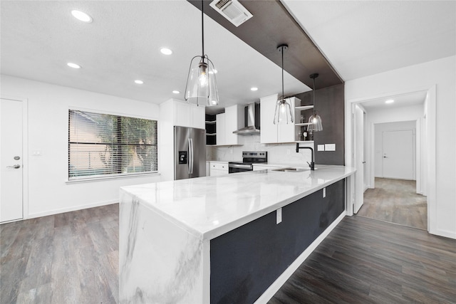 kitchen with visible vents, open shelves, stainless steel appliances, a peninsula, and wall chimney exhaust hood