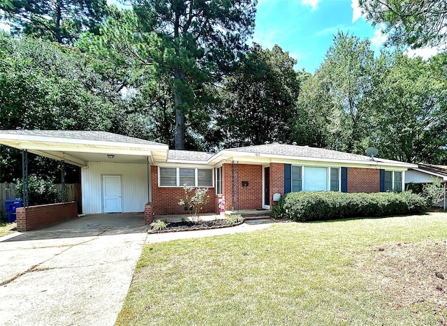 ranch-style home featuring brick siding, an attached carport, concrete driveway, and a front yard