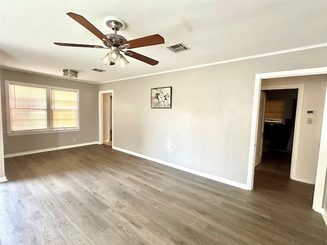 unfurnished room with visible vents, wood finished floors, ceiling fan, and crown molding