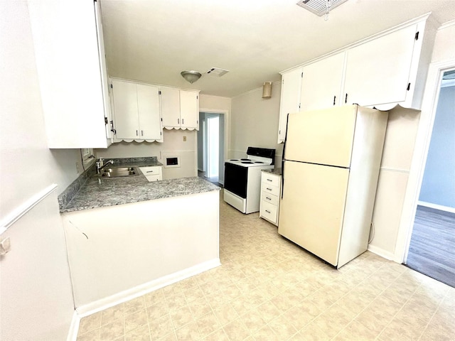 kitchen featuring range with electric cooktop, a sink, white cabinetry, freestanding refrigerator, and light floors