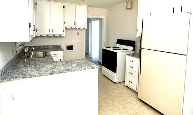 kitchen featuring freestanding refrigerator, a sink, ornamental molding, range with electric cooktop, and white cabinets