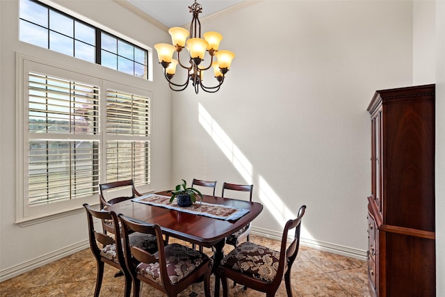 dining area with a chandelier, crown molding, and baseboards