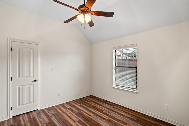 empty room featuring lofted ceiling, baseboards, dark wood-style flooring, and ceiling fan