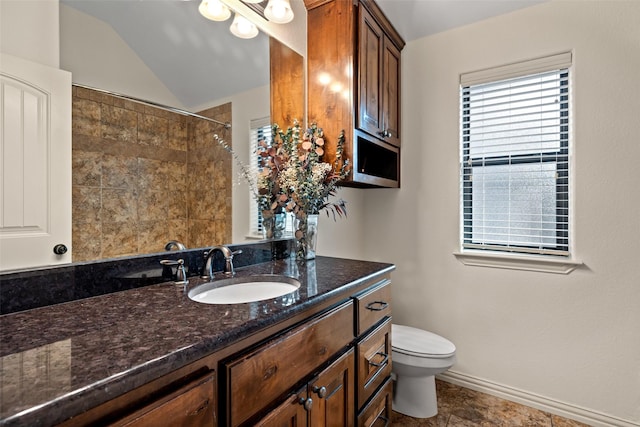 bathroom with vanity, a shower with curtain, baseboards, vaulted ceiling, and toilet