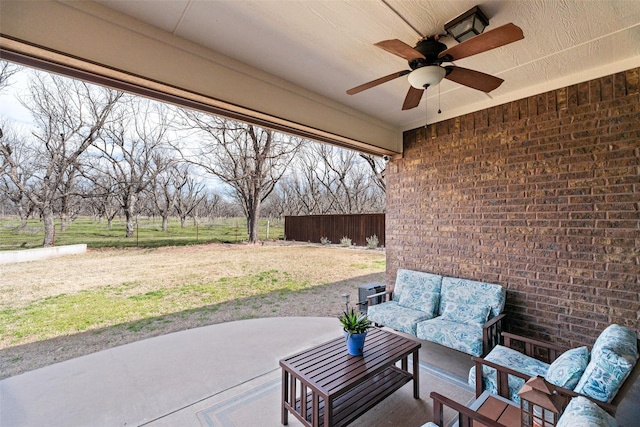 view of patio featuring outdoor lounge area, a ceiling fan, and fence