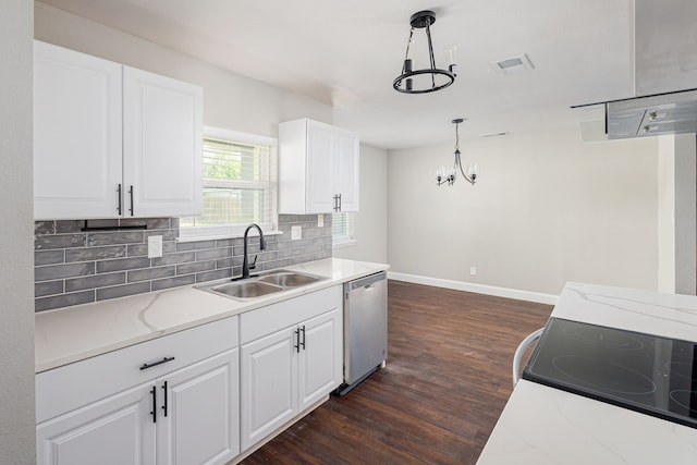 kitchen featuring dark wood-style flooring, a sink, decorative backsplash, dishwasher, and a notable chandelier