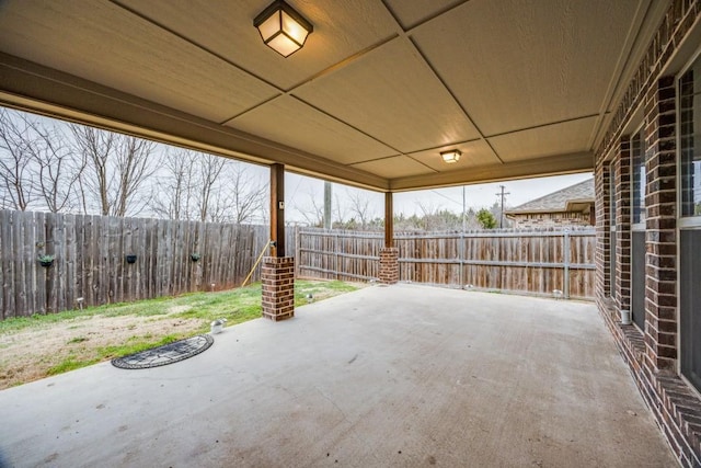 view of patio / terrace featuring a carport and a fenced backyard