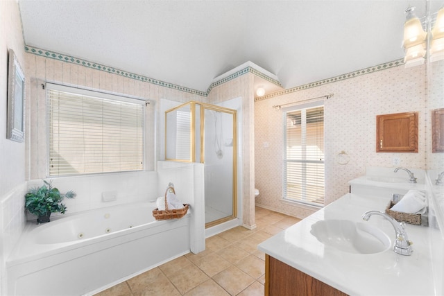 bathroom with wallpapered walls, double vanity, a stall shower, and a sink