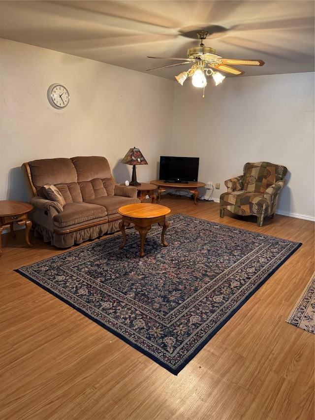 living room with a ceiling fan and wood finished floors