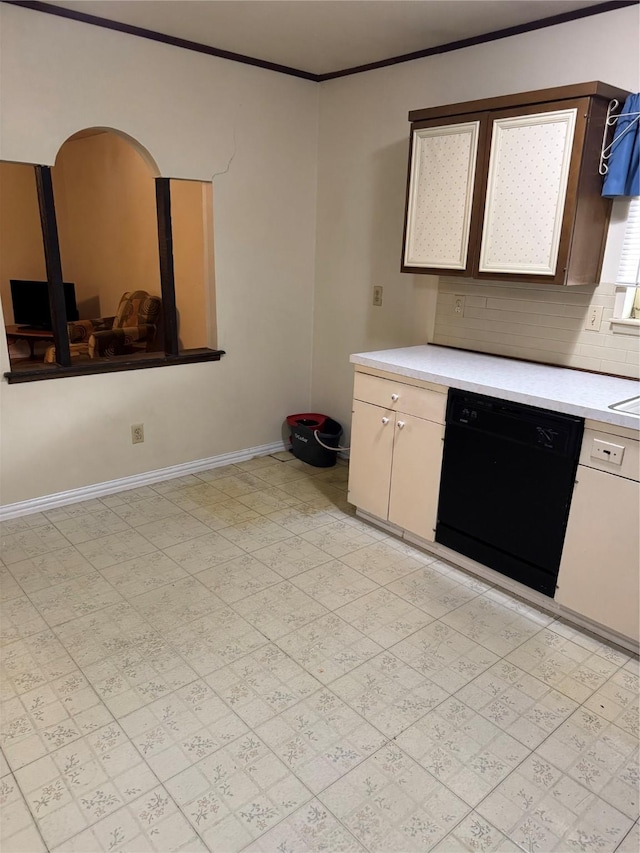 kitchen with backsplash, baseboards, light countertops, black dishwasher, and ornamental molding