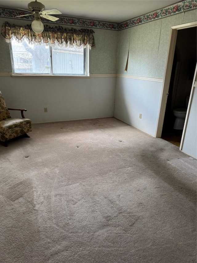 spare room featuring ceiling fan and carpet flooring