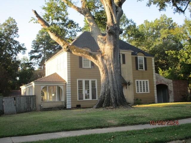 view of front of property with a front yard and fence