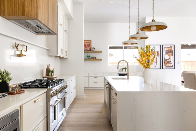 kitchen featuring open shelves, a sink, light wood-style floors, range with two ovens, and extractor fan