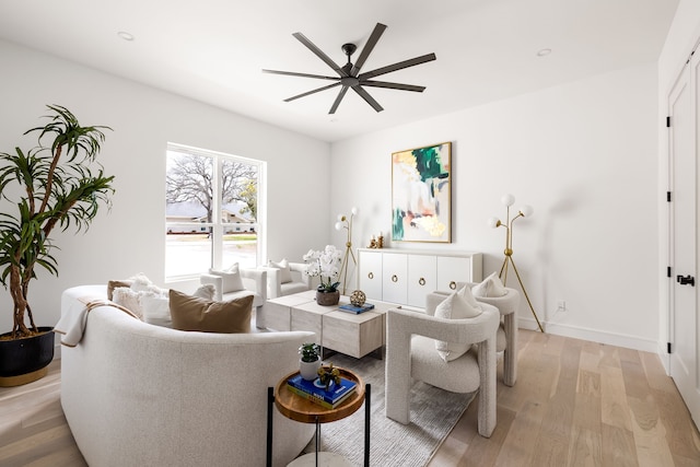 living area featuring recessed lighting, baseboards, light wood-style floors, and a ceiling fan