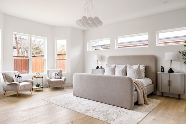 bedroom with baseboards and light wood-style floors