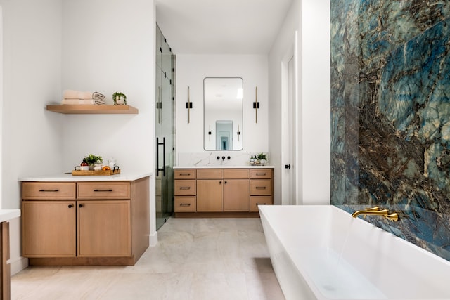 full bath featuring vanity, a shower stall, and a freestanding tub