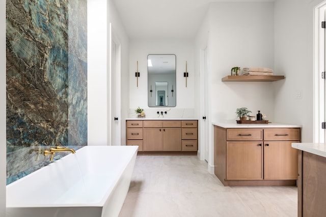 bathroom featuring a soaking tub and vanity