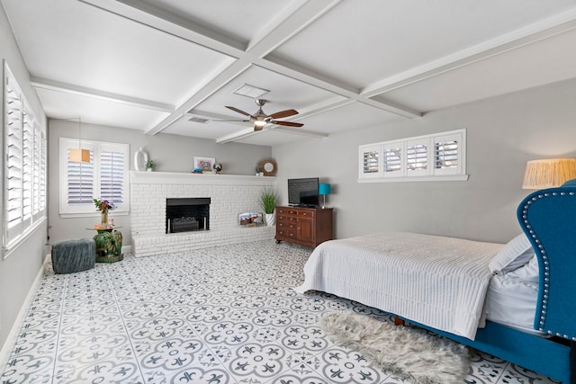 bedroom with a ceiling fan, baseboards, coffered ceiling, beam ceiling, and a brick fireplace